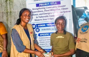 Beneficiaries from Western Area Urban communities receive cash assistance through a Caritas Freetown disaster preparedness project
