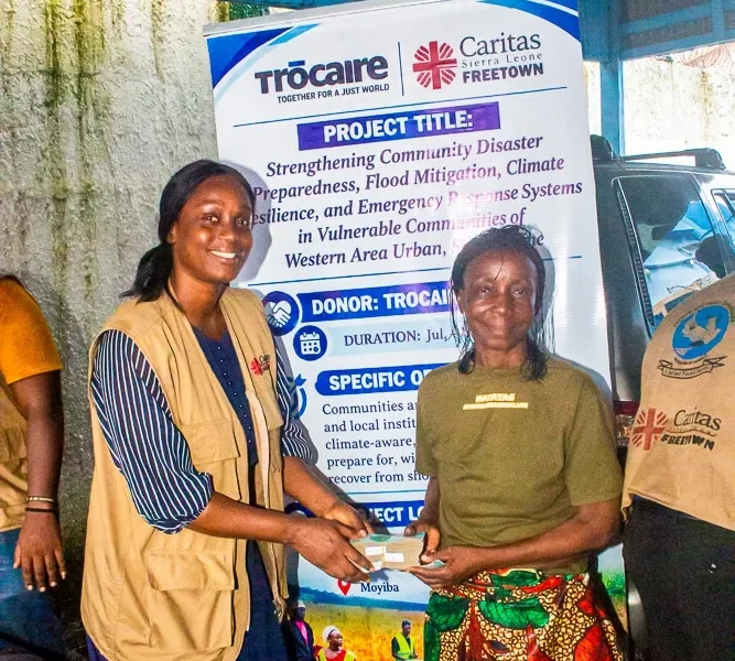 Beneficiaries from Western Area Urban communities receive cash assistance through a Caritas Freetown disaster preparedness project