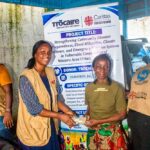 Beneficiaries receive cash assistance through a Caritas Freetown disaster-preparedness project in Wellington
