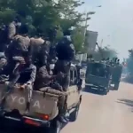 Soldiers carrying Ethiopian flags walk through Alamata amid renewed fighting in northern Ethiopia