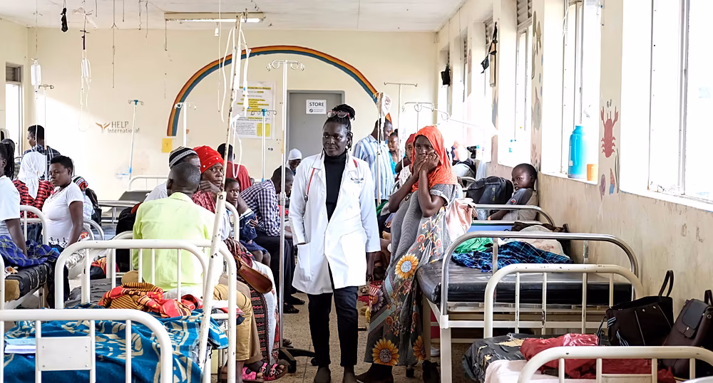Healthcare workers and families receiving sickle cell care at a clinic in Uganda