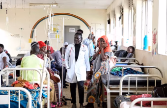 Healthcare workers and families receiving sickle cell care at a clinic in Uganda